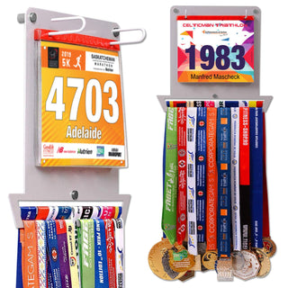 Race Bib Holder + Medal Hanger Display Rack V1 by Victory Hangers® in grey, showcasing race bibs and medals for runners in a compact wall-mounted design.