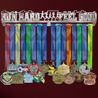 Run Hard Feel Good Medal Hanger holding a full row of medals on a wall