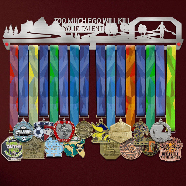 Too Much Ego Will Kill Your Talent Medal Hanger holding a full row of medals on a wall