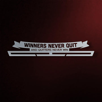 Winners Never Quit Medal Hanger in laser-cut steel on a dark background